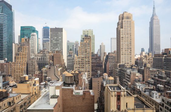 New York city skyline. Aerial view of Manhattan skyscrapers and Empire state building, blue sky with clouds background